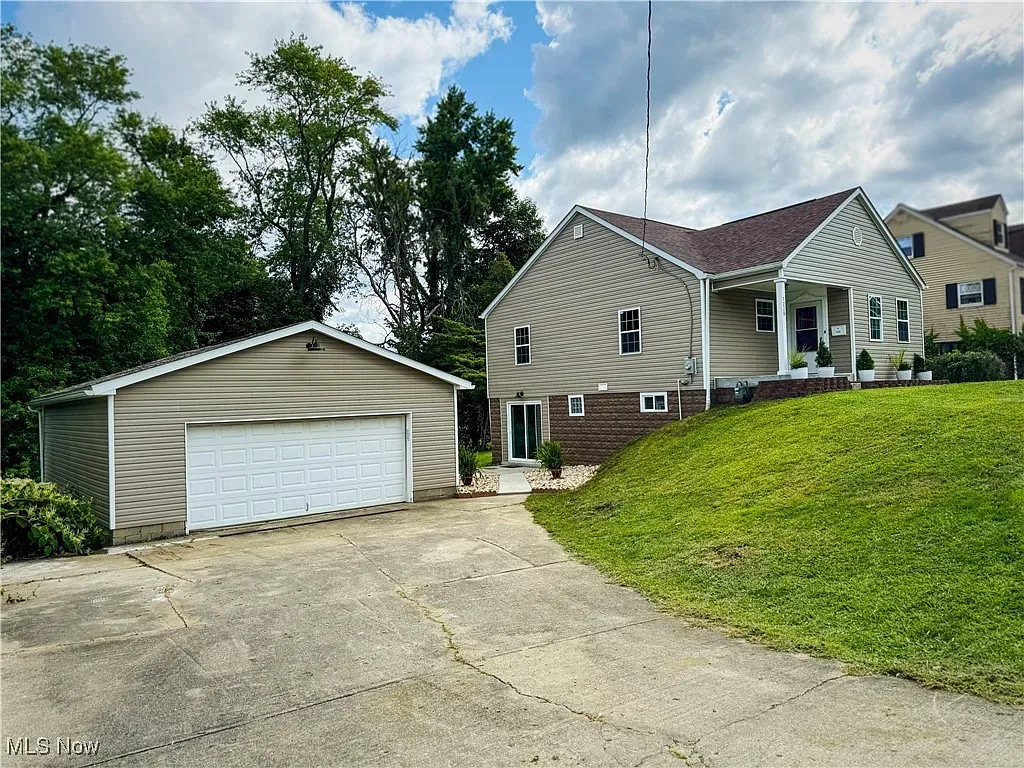 Completed roofing and exterior renovation with detached garage