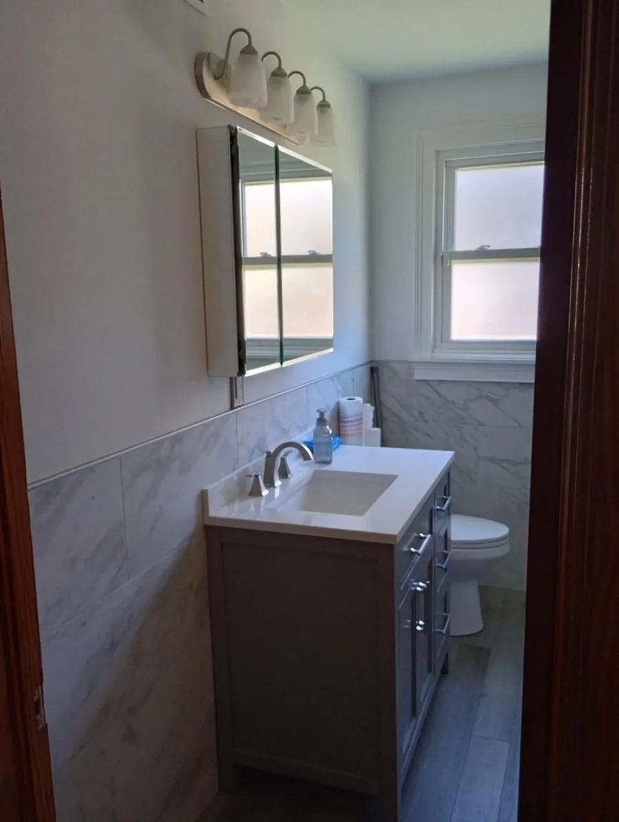 Bathroom remodel with marble tile and vanity