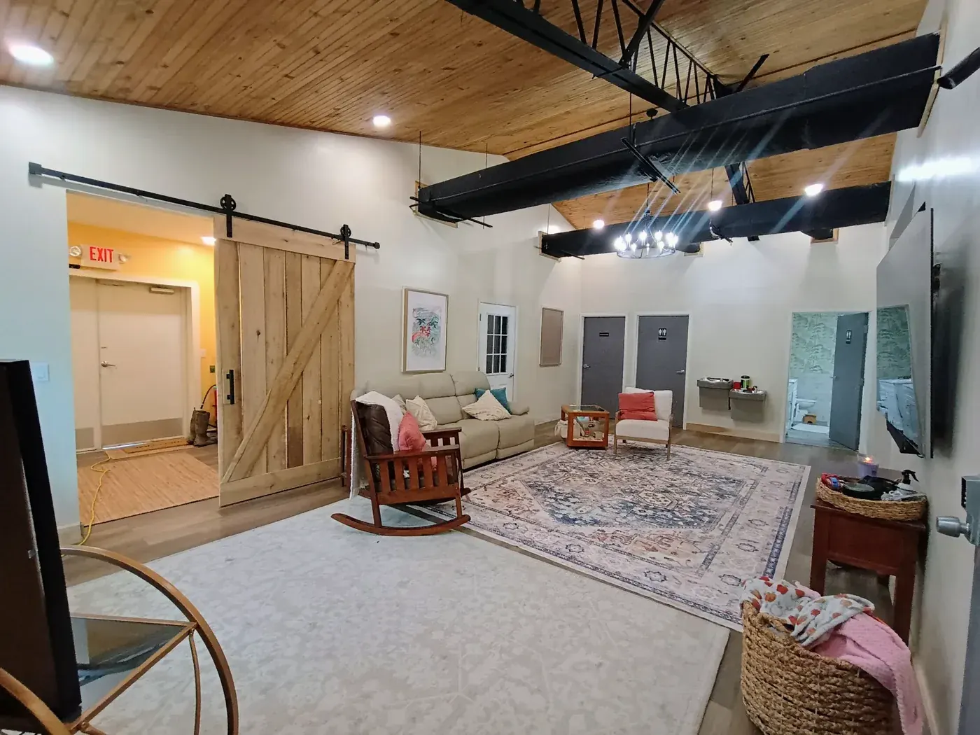Home addition wide view with open sliding barn door and full living space